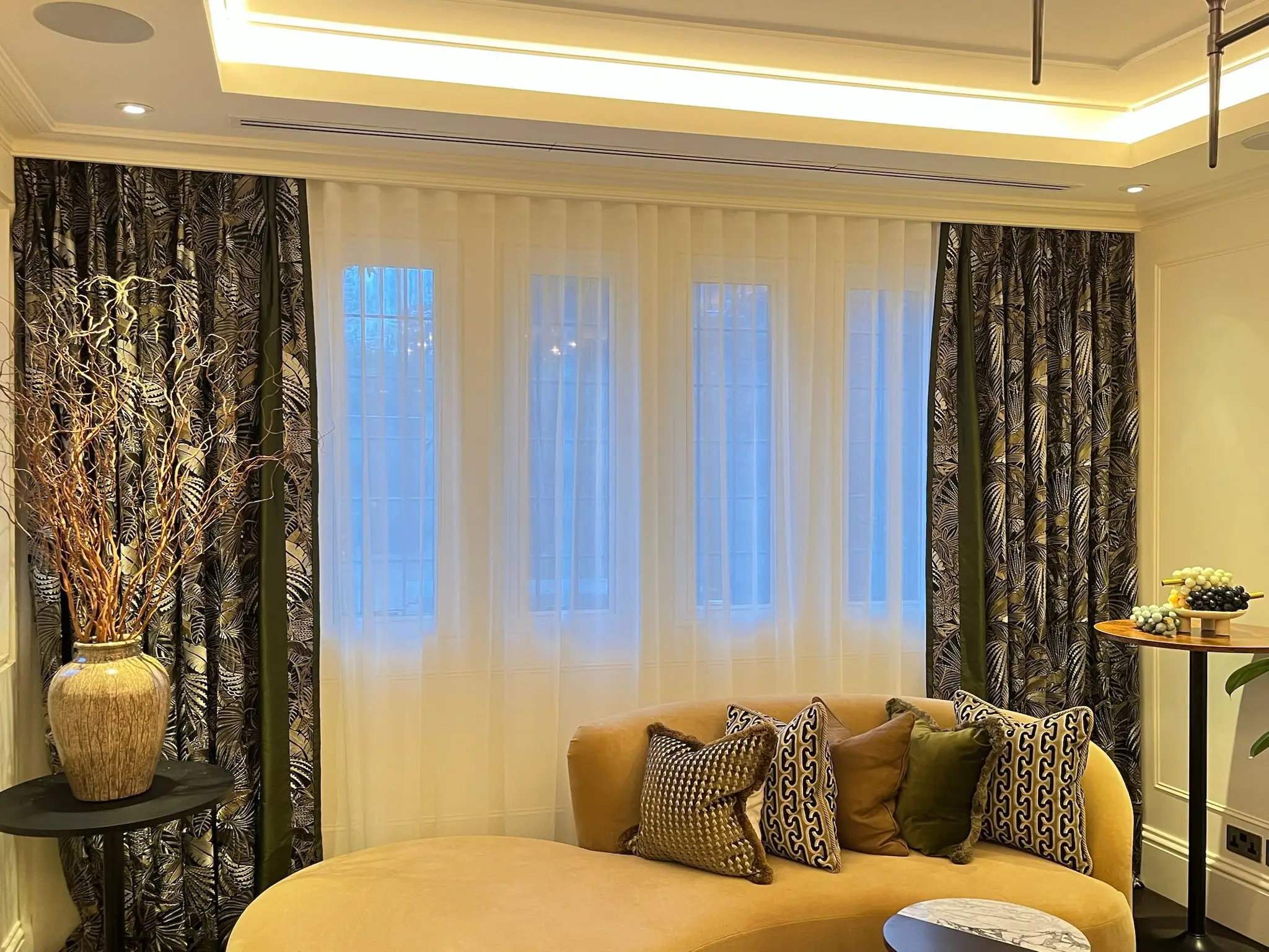 Upholstered seating and occasional tables in a finished reception room